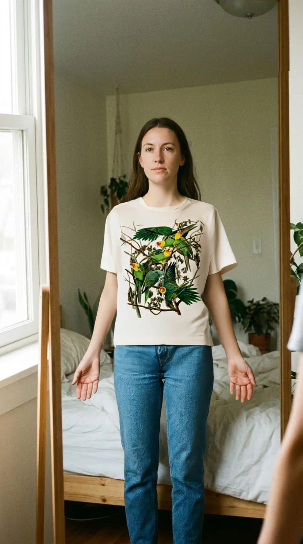 An AI generated on-model shot: the printed tee worn in a bedroom mirror, the hem at the waist and the chest print at its real size